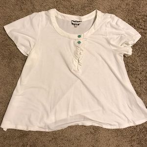 Boutique ivory tee with ruffle and button details